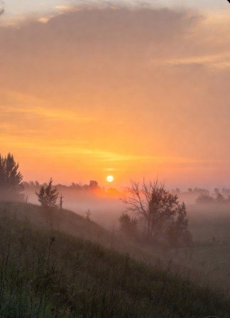 Dawn breaking over tranquil fields