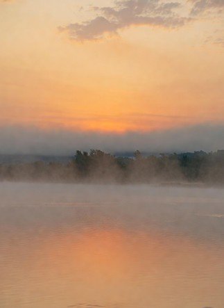 Serene morning lake with misty background