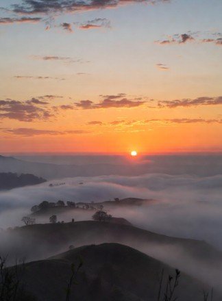 Sunrise over foggy hills landscape photo