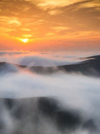 Sunrise over foggy hills landscape photo