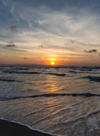 Tranquil beach sunrise with calm waves