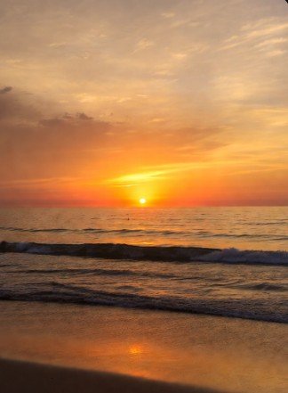 Tranquil beach sunrise with calm waves