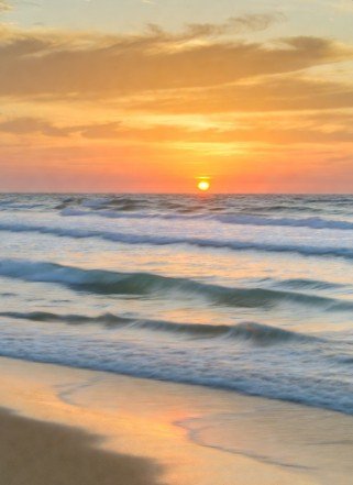 Tranquil beach sunrise with calm waves