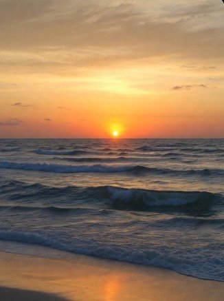 Tranquil beach sunrise with calm waves