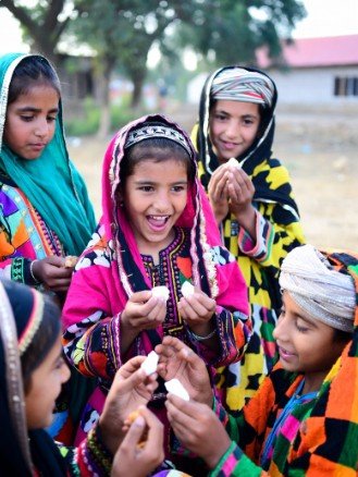 Children in Traditional Clothes Sharing Sweets1
