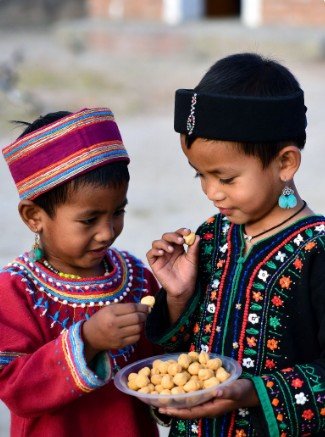 Children in Traditional Clothes Sharing Sweets4