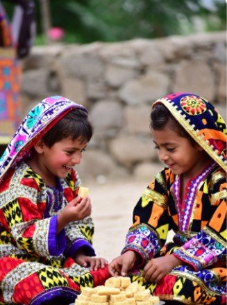 Children in Traditional Clothes Sharing Sweets5