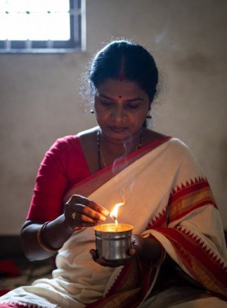 Woman doing morning puja with diya4
