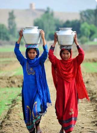 Women in Traditional Dress Carrying Pots1
