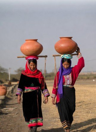 Women in Traditional Dress Carrying Pots4